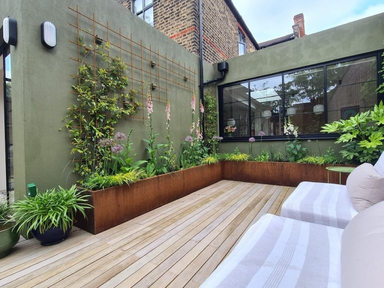 Investing in outdoor spaces: why corten steel planters are a smart long-term choice Large Corten steel planters featuring late summer ornamental grasses in a UK garden