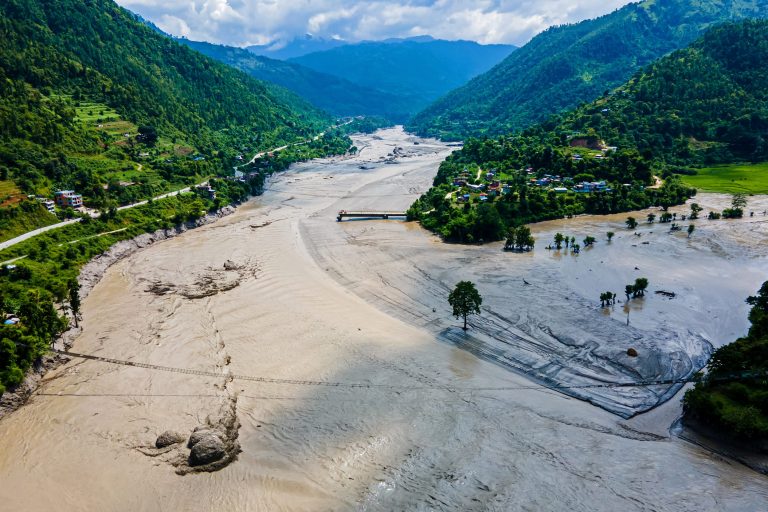Nepal flood rescue teams working among damaged buildings and debris after the August 2026 flash floods